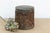 A sophisticated example of a traditional Chinese tea canister, designed to preserve the delicate flavor and aroma of...
