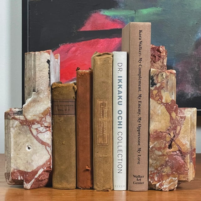 18th Century Antique Italian Marble Remnant Bookends. Hues of red, mustard, and pink. Hand carved floral detail on the...