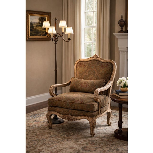 MOBILE-READY DESCRIPTION A refined Thomasville French Provincial style armchair featuring a carved, antiqued wood frame...