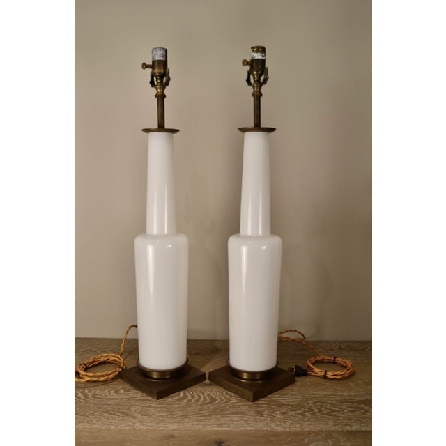 Hard to find pair of discontinued Fiona table lamps by Thomas O'brien for Visual Comfort. White glass and naturally aged...