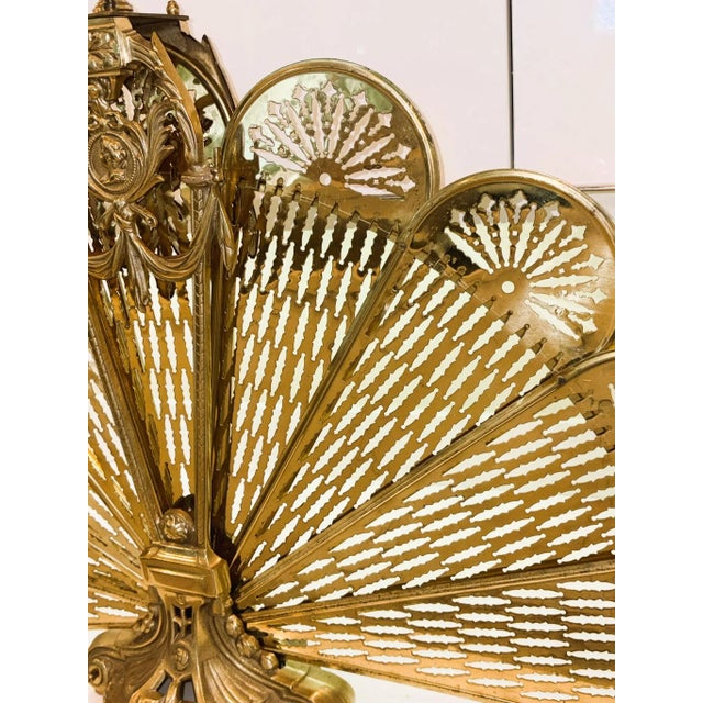 Vintage French Brass Peacock Fan Folding Fireplace Screen With Laurel Swag & Cameo A striking vintage peacock fire screen...
