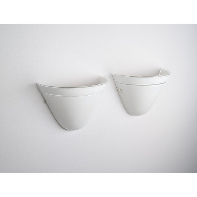 Pair of wall sconces manufactured by Murano Due in Italy, 1980s. They are crafted from Murano glass, blown using the...