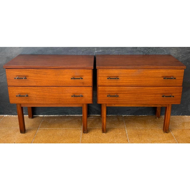 Pair of Scandinavian Mid-Century Modern nightstands crafted in teak, dating to the 1960s. Each piece features a clean...