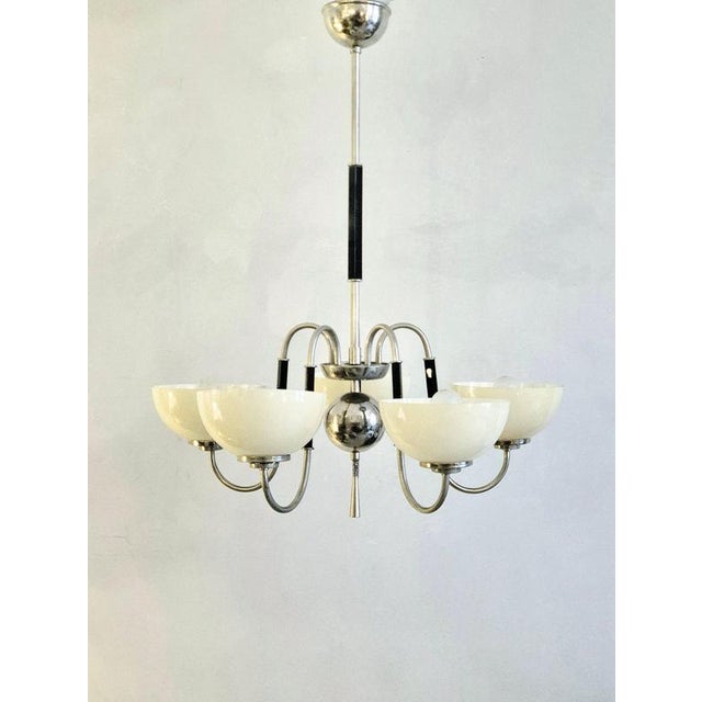 A beautiful swedish grace / art deco pendant with opal cream white original shades. Attributed cg hallberg, sweden...