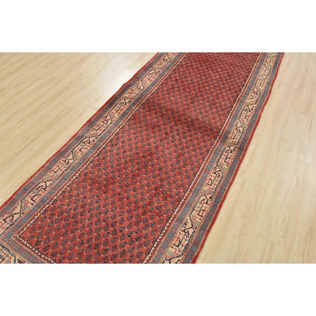 An authentic vintage tribal Mir runner hand-knotted with fine wool and natural dyes. This oriental rug features an all-...