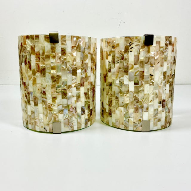 This pair of electrical Wall Sconces are lovely. They feature a curved glass front panel that has been covered with Capiz...