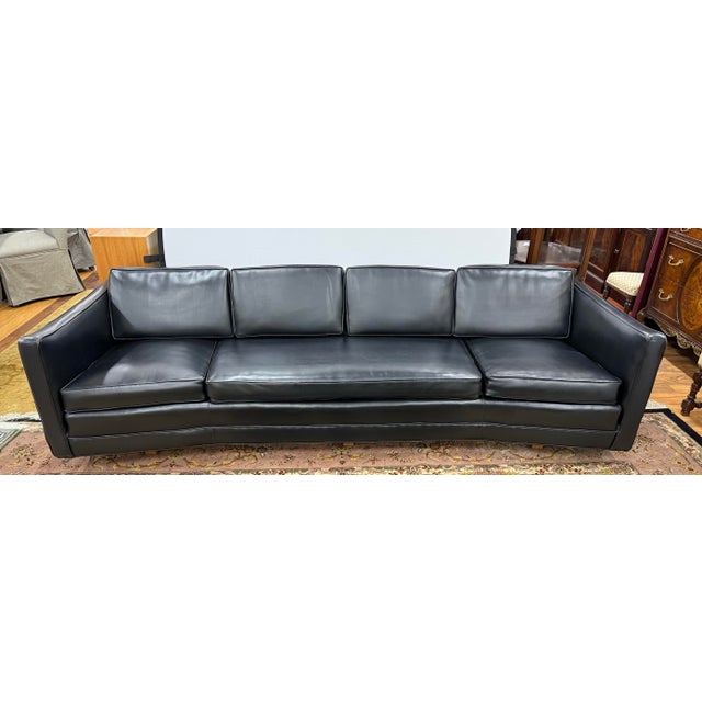 Discover this classic vintage black naugahyde sofa crafted with impeccable attention to detail combining sleek lines and...
