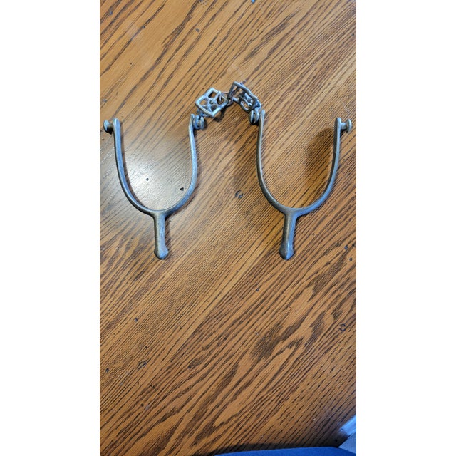Rare find, pair of vintage solid metal spurs with metal buckle and brass color. One spur is stamped U.S. A and the other...