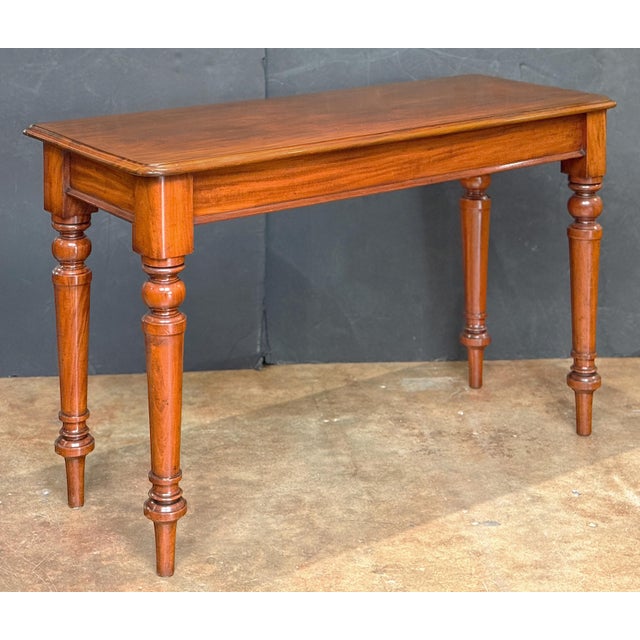A fine English serving console or hall table of mahogany from the William IV era, featuring a moulded rectangular top set...