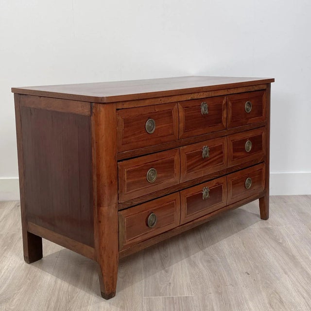 An early 19th Century mixed wood inlaid commode, Italy circa 1820.