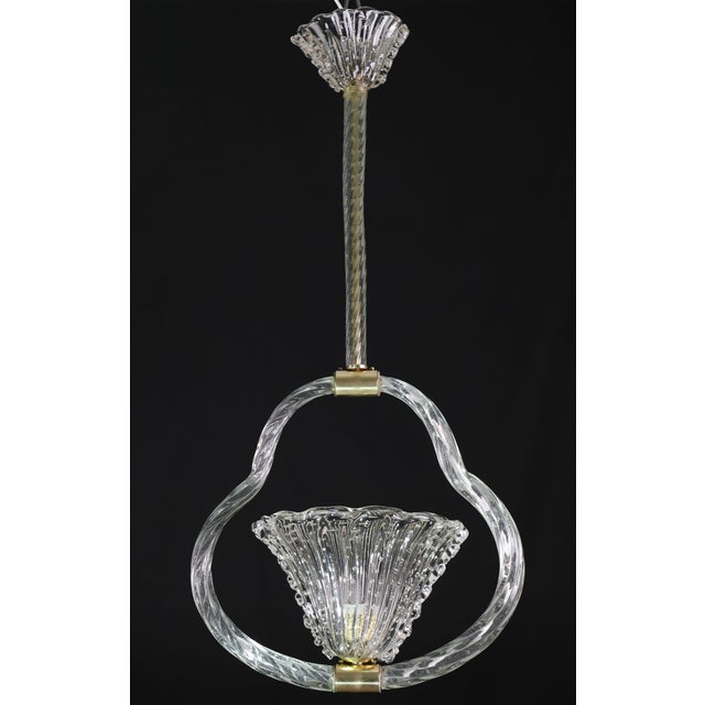 Elegant chandelier attributed to Ercole Barovier. 1940s period. A stupendous work in glass, the cup with a "bullicant"...