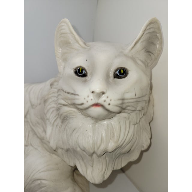This pretty life size cat has white fur with light gray around the feet and spine. Heavy.