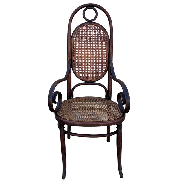 Victorian high-back Thonet number 17 armchair features an elegant, sculptural frame crafted from warm-toned bentwood with...