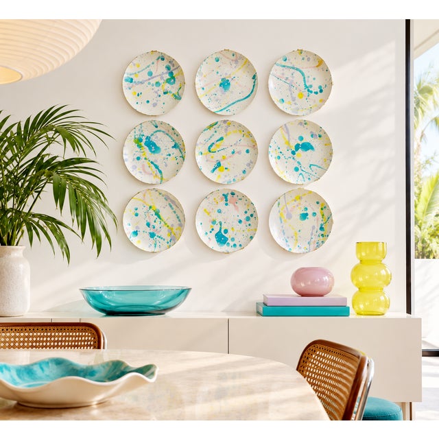 A one-of-a-kind set of 10-inch ceramic dinner plates, hand-decorated with purple, teal, yellow and pink splattered glaze....