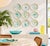 A one-of-a-kind set of 10-inch ceramic dinner plates, hand-decorated with purple, teal, yellow and pink splattered glaze....