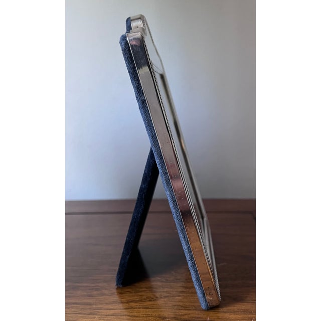 This lovely Traditional sterling silver frame features a classic beaded edge and Blue velvet easel back. Has a medallion...