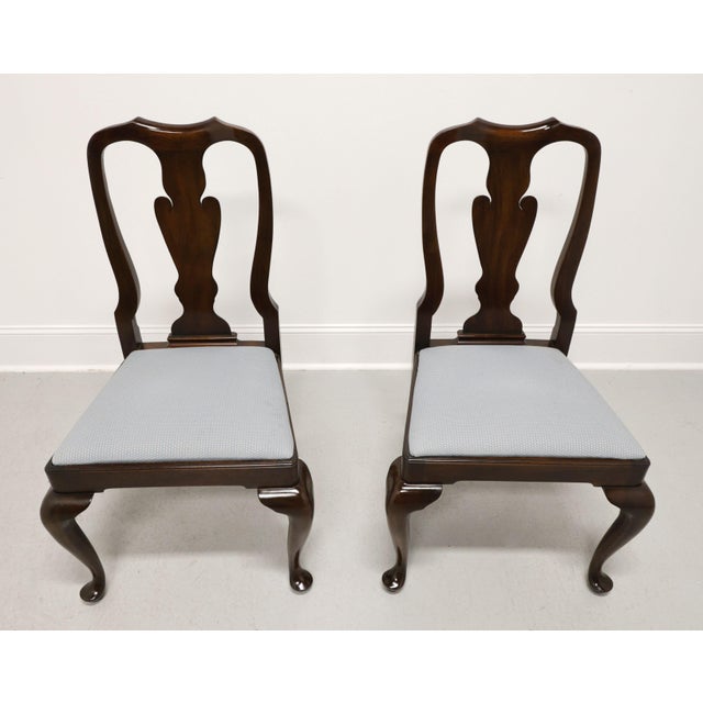 A pair of Queen Anne style dining side chairs by Henkel Harris of Winchester, Virginia, USA. Solid mahogany, carved crest...