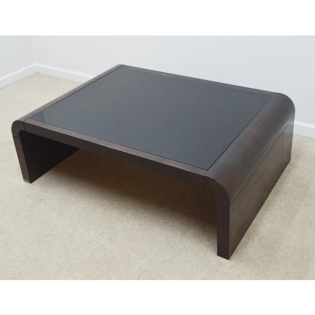 Coffee Table by Ralph Lauren. Store item # 256. It features modern design and glass top.