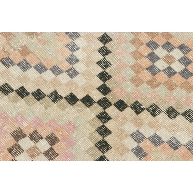 Made with hand-knotted wool circa 1950-1960, this 4x7 vintage Turkish rug of all over floral medallion design is an...