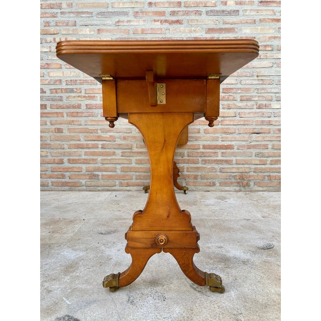 Mid-20th century winged console table in walnut with claw feet in bronze, two drawers and wheels. Fabulous walnut inlaid...