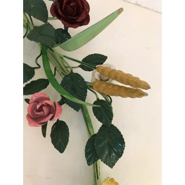 A rare refreshing large vintage iron and tole painted wreath wall sculpture having a whimsical arrangement of tole flowers...