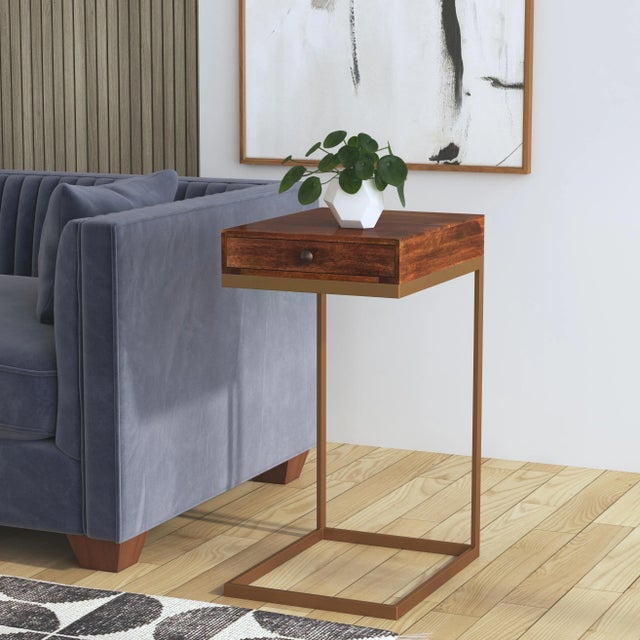 This C-shaped end table is beautifully crafted piece that features one pull out drawer, a rich walnut brown finish and an...