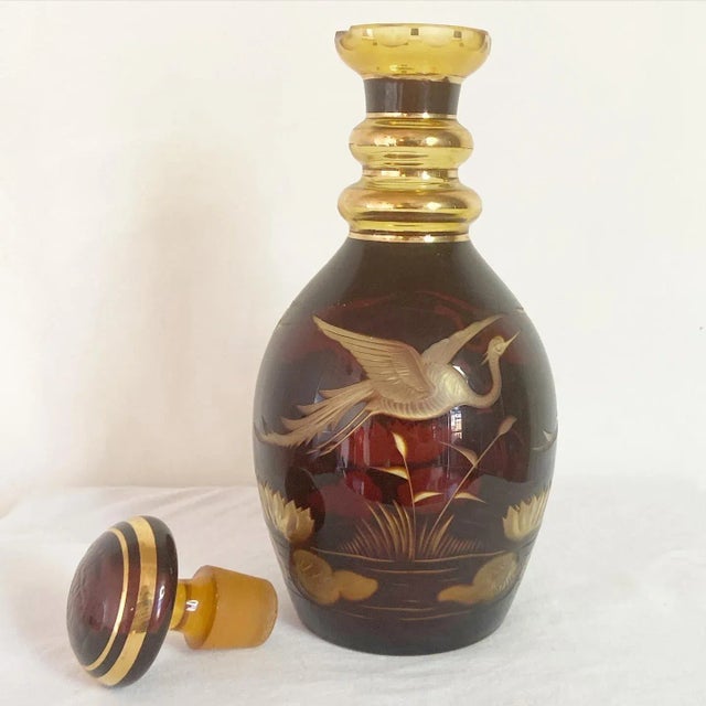 Exceptional bohemian decanter with matching glasses. Displays an etched swan on the decanter. Decanter measures 4.5”W,...