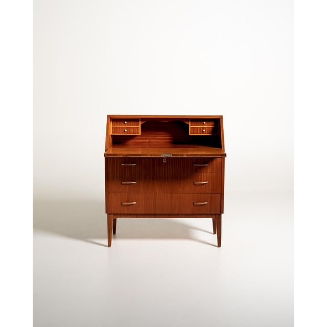 Mahogany secretary with flap, three large drawers, compartments, and small internal drawers. Brass handles. Scandinavian...