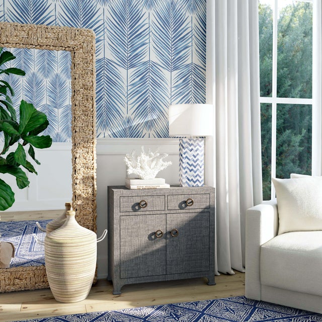 Make a statement in your dining room or living room with this textured cabinet. The natural weave of the raffia adds...