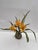 Foreshadow III by Ashley Folkner | Cement and wood sculpture of yellow flowers with leaves For Sale