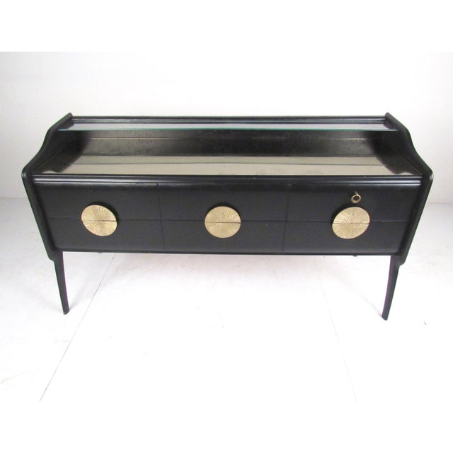 This unique vintage sideboard features two-tier glass top with small storage shelf built into the Italian modern design....