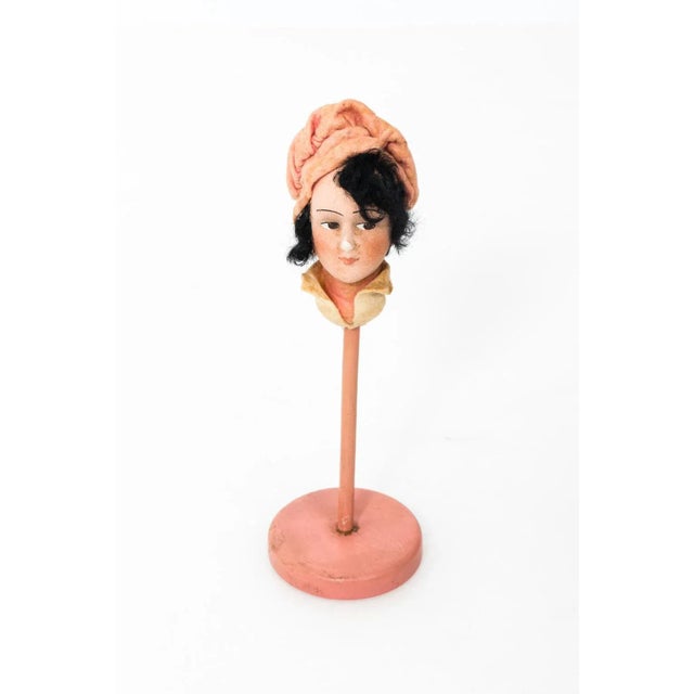 Set of five papier Mache hat stands use in a millinery shop for the display of hats, circa 1920s. Each stand depicts a...