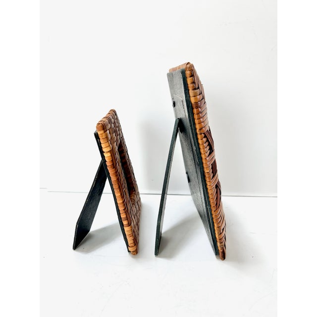 A beautifully textured set of two vintage woven rattan picture frames, featuring rich tonal variation and intricate...