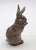 Royal Copenhagen bunny, circa 1950s, Denmark. Blue-grey white tailed bunny sitting up eating a bit of lettuce with ears...
