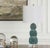 The Bonaire lamp showcases a captivating ceramic base of stacked spheres, each adorned with carefully folded and layered...