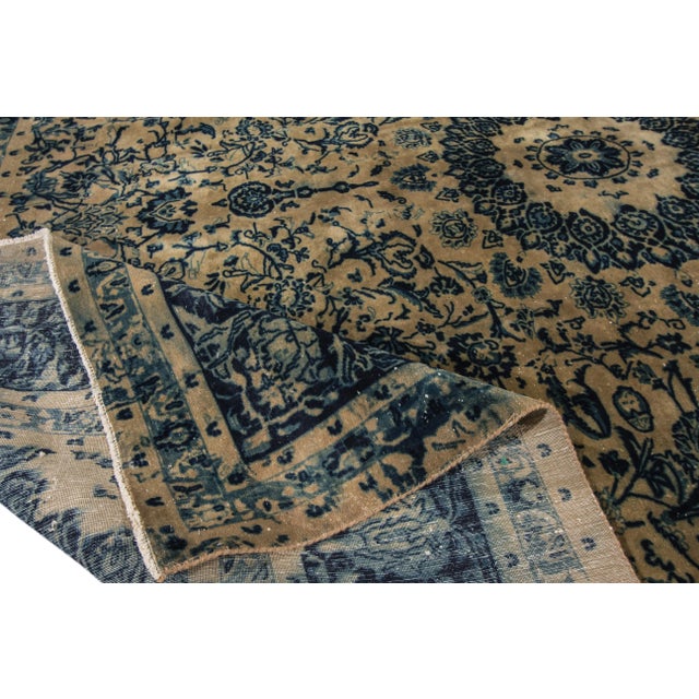 Beautiful vintage Persian Tabriz hand-knotted shabby chic wool rug with a beige field. This piece has navy blue accents in...