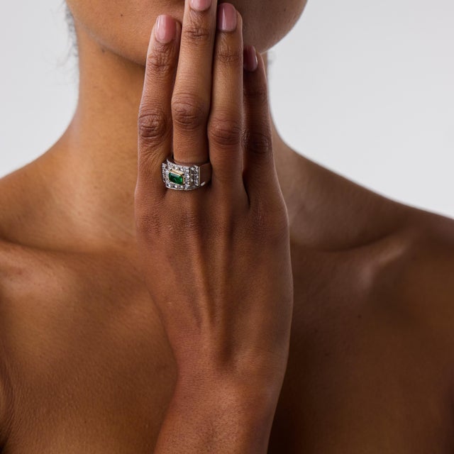 This striking Retro style emerald and diamond tank ring is a bold contemporary design inspired by the powerful glamour of...