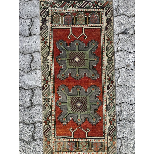 This is a vintage Turkish Oushak rug from the 1960s. The piece was hand-knotted.