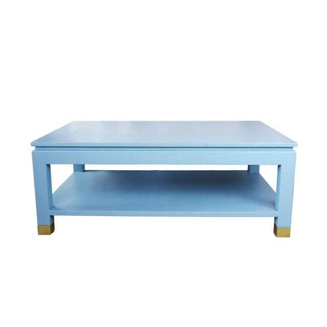 Karl Springer Style Modern Light Blue Raffia Coffee Table. with four brass sabot Carl Springer Style Blue Raffia Coffee...