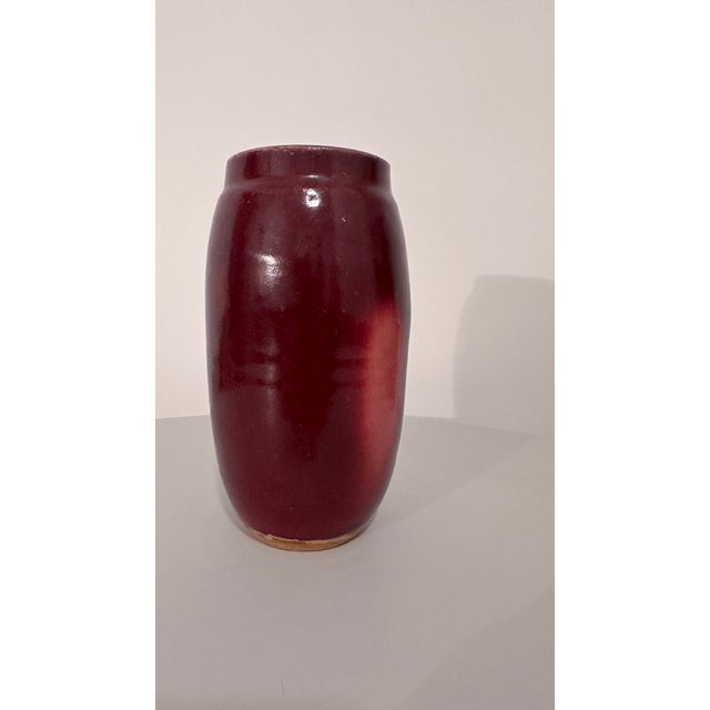 This antique ox blood glaze handmade stoneware vase is a unique piece of art pottery produced using traditional pottery...
