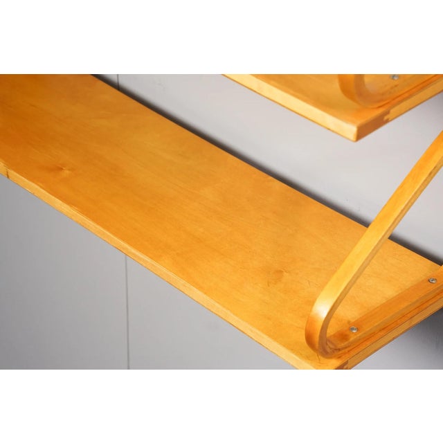 An iconic double wall shelf, model 112B-2, designed by Alvar Aalto and manufactured by Huonekalu-ja Rakennustyotehdas OY...
