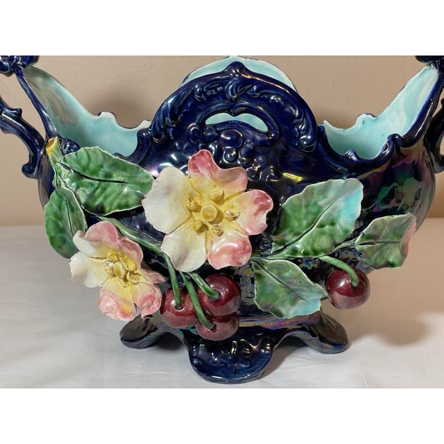 Barbotine Majolica cobalt and aqua blue jardiniere footed basket decorated with flowers and cherries. The surface of the...