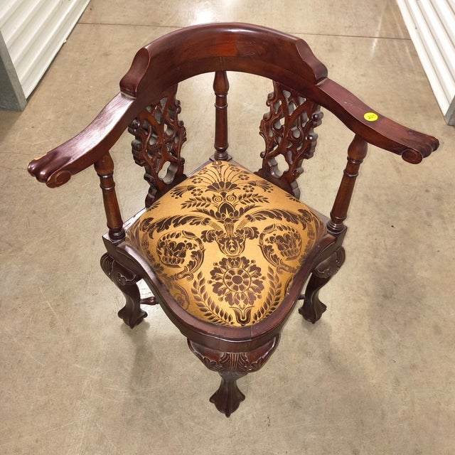 Triangular/splayed seat designed to fit into a corner Three legs (one at the front, two at the back) with carved feet...