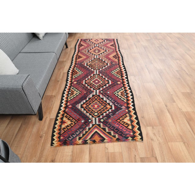 Vintage Hand-Knotted runner rug is a semi-antique vintage area rug. The '70s Eastern region of Anatolia's unique rug is...