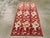 This Mid-20th century Turkish Anatolian rug, measuring 3' 1" x 5' 9", presents a charming floral design that blends...