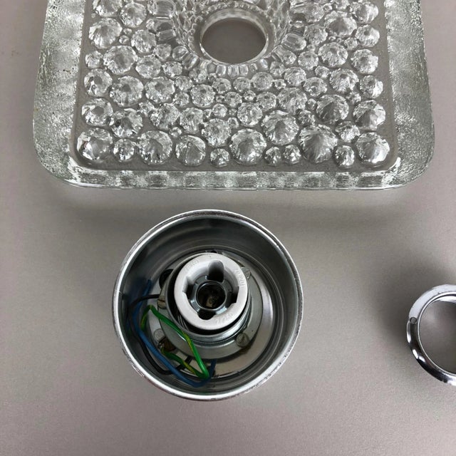 Original 1970s modernist German wall Light made of glass and metal. This super rare wall light was produced in the 1970s...