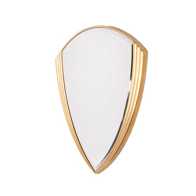 Beautiful Hollywood Regency brass wall mirror, Belgium, circa 1970–1975 Shield-shaped wall mirror produced in Belgium...