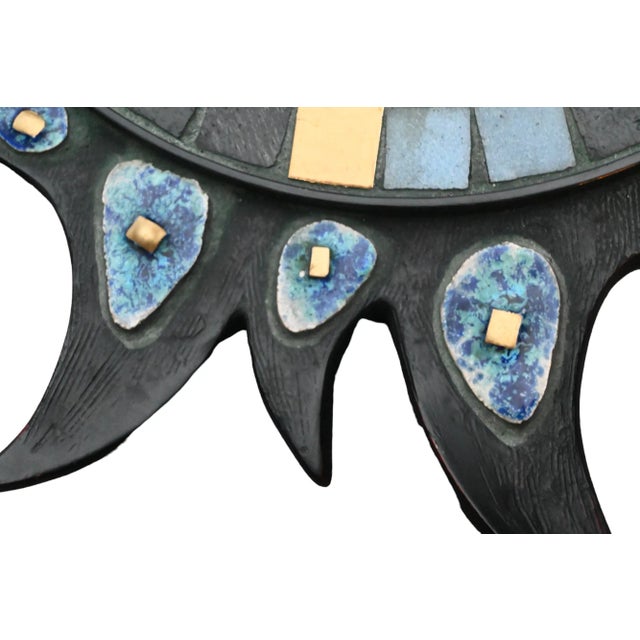 This stunning vintage sunburst convex mirror features blue glazed ceramic accents and copper details on quality resin with...