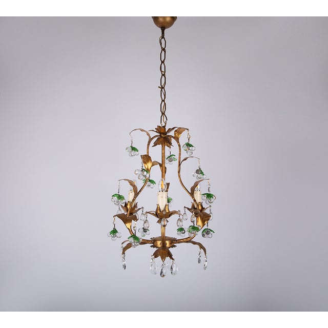 Indulge in the artistry of italian craftsmanship with this exquisite gilt chandelier, adorned with hand-blown murano glass...