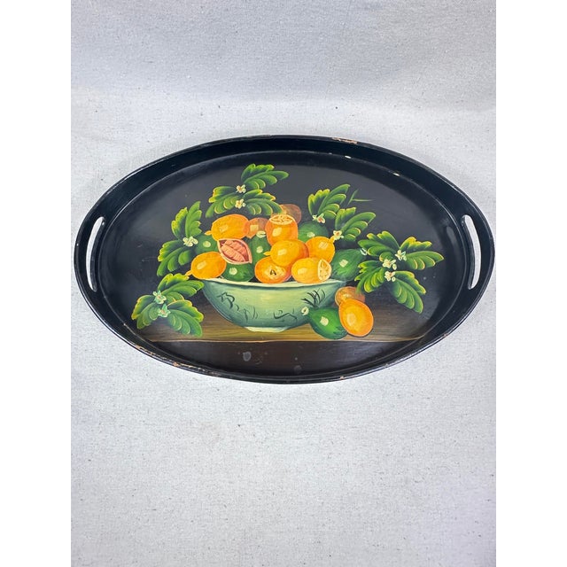 Bring an elegant touch to your tabletop or wall display with this striking vintage oval serving tray. Crafted of wood with...